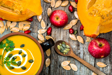 Cream soup from pumpkin with seeds, cooking concept