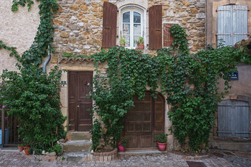 Fototapeta na wymiar The facade of an old house in the French village Vallon Pont d'Arc.