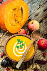 Pumpkin soup with cream and parsley, healthy food cooking concep