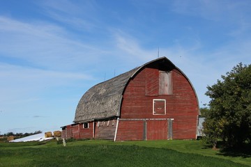 Red hip-roof barn on the farm