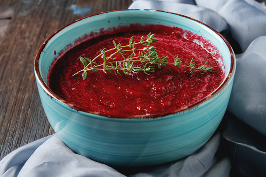 Traditional beetroot soup in a blue plate with Temyan. Dark wood