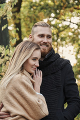 Fototapeta premium Redhead bearded male hugging cute blonde female.