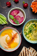 Various vegetarian colorful dips with pita bread