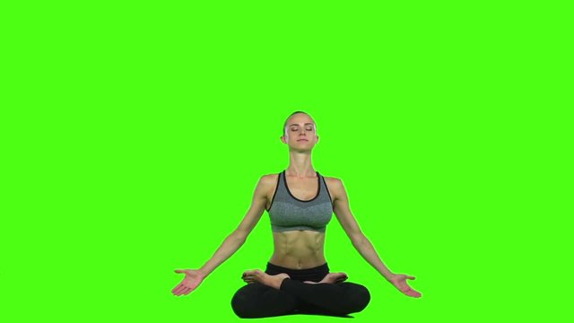 Brunette young woman doing yoga. Green screen. Slow motion