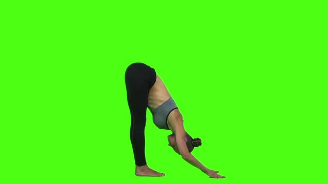 Fitness active woman doing relaxing exercise yoga. Green screen. Slow motion