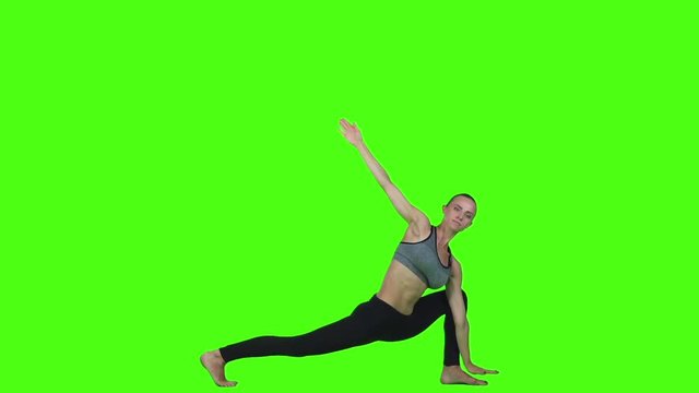 Girl in a top and leggings doing yoga. Green screen. Slow motion