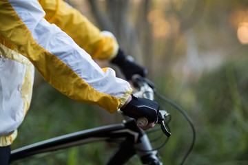 Mid-section of male biker with mountain bike