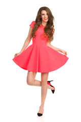 Woman In Pink Mini Dress Posing On One Leg