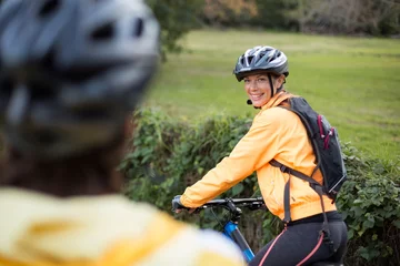 Foto auf Glas Female biker smiling while cycling © WavebreakMediaMicro