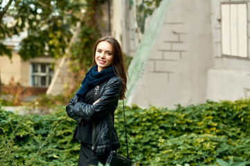 Outdoor portrait of young beautiful girl in town .