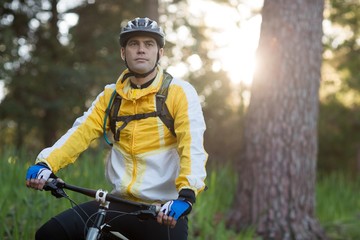 Fototapeta na wymiar Male biker with mountain bike in forest