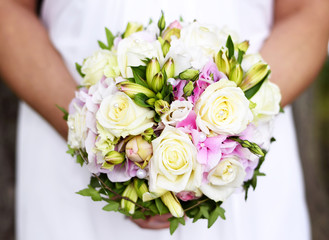 Wedding bouquet with white roses and decorative pearls. Bride holding her flower bouquet.