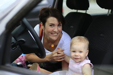 Small cute baby and mom in a car