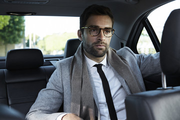 Businessman on the move in car
