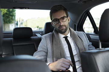 Smart businessman in car, content