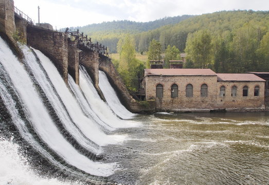 Summer landscape of the old dam on the river