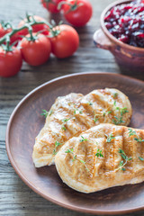 Grilled chicken with cranberry sauce and fresh cherry tomatoes