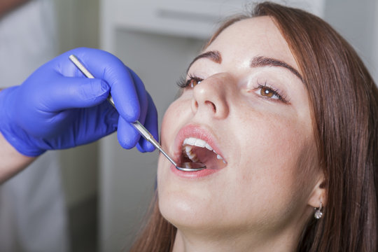 Patientin l&auml;&szlig;t sich vom Zahnarzt untersuchen