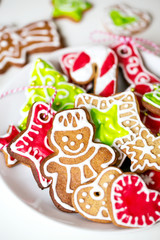Different Christmas cookies on a plate on a white background