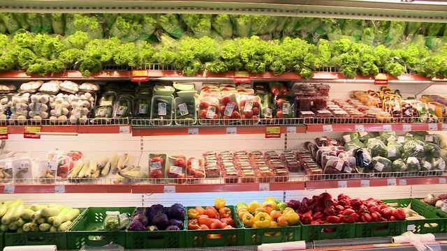 Fresh vegetables on the shelves of the supermarket.Colorful vegetables and herbs.