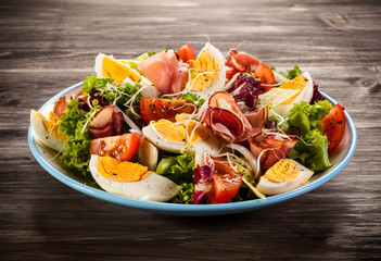 Boiled eggs with smoked ham and vegetables