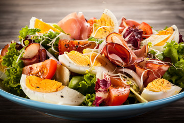 Boiled eggs with smoked ham and vegetables