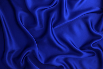 Close up wave  luxury blue silk or satin fabric background