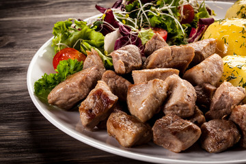 Grilled meat with boiled potatoes and vegetables