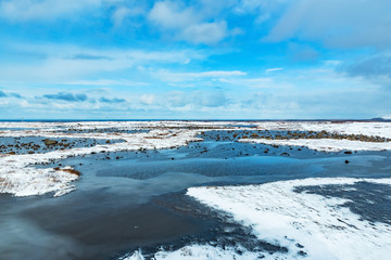 landscape of iceland with frozen rivers at wintertime