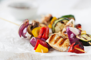 Closeup of chicken skewers or shashlik with grilled vegetables