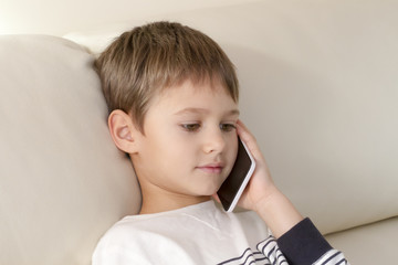 Child talking on the mobile phone. Education, leisure, technology concept