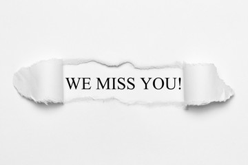 We miss you! on white torn paper - obrazy, fototapety, plakaty