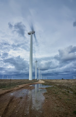 Wind turbine farm over the blue cloudy sky