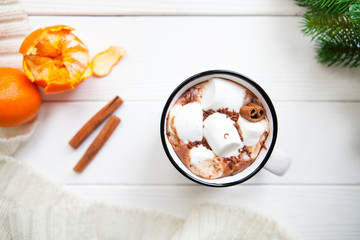 Hot chocolate with marshmallows in a ceramic cup, cinnamon stick