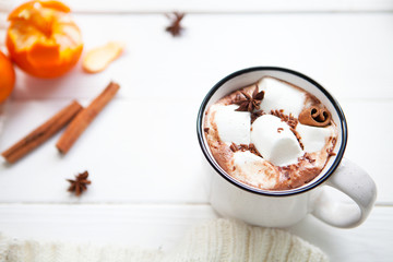 Hot chocolate with marshmallows in a ceramic cup, cinnamon stick