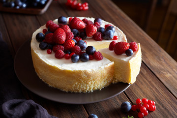 Homemade Christmas winter berry fruit cheesecake on wooden dark table. Creamy mascarpone dessert. ozy atmospheric photo.