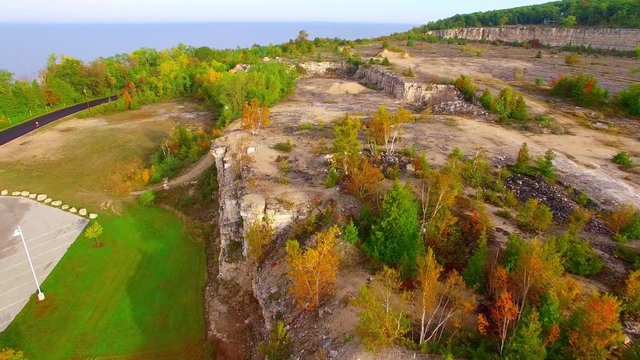 Amazing scenic man-made cliffs remaining from old rock quarry, aerial view.
