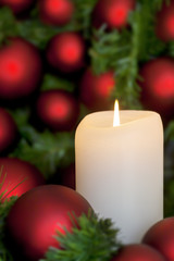 Christmas Candle with Red Baubles over Black
