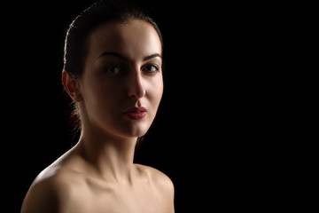 Fototapeta premium sad beautiful woman looking at camera on black background