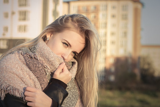 sad pensive blond girl in scarf toned image