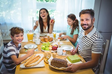 Happy family having breakfast together