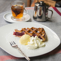 Slice of cherry tart and hot tea