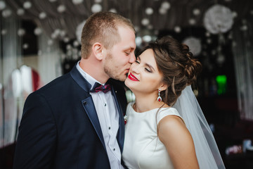 Wedding. Groom kisses bride after wedding ceremony. Romantic momment