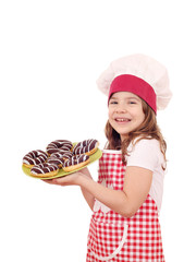 happy little girl cook with sweet chocolate donuts