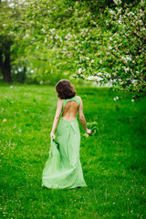 Obraz premium beautiful young woman walking in a green garden