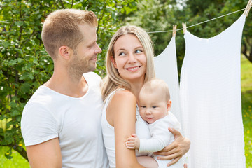 Happy family with a baby outdoors