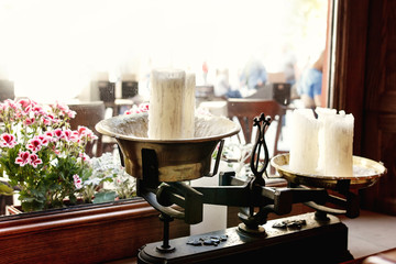 old big vintage candles at window in rich restaurant