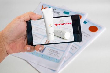 Augmented reality marketing concept. Hand holding smart phone to use A/R application to product detials for A/R catalog.