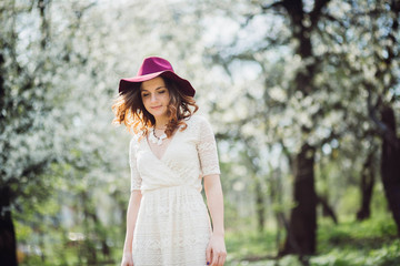 beautiful young woman walking in the green garden