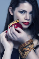 Portrait of a young beautiful woman with a snake.